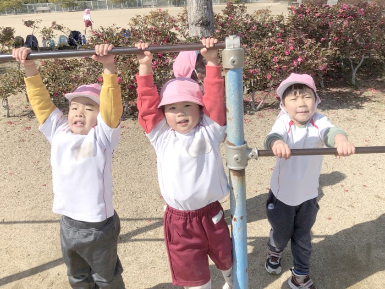 鉄棒で遊ぶ園児の写真