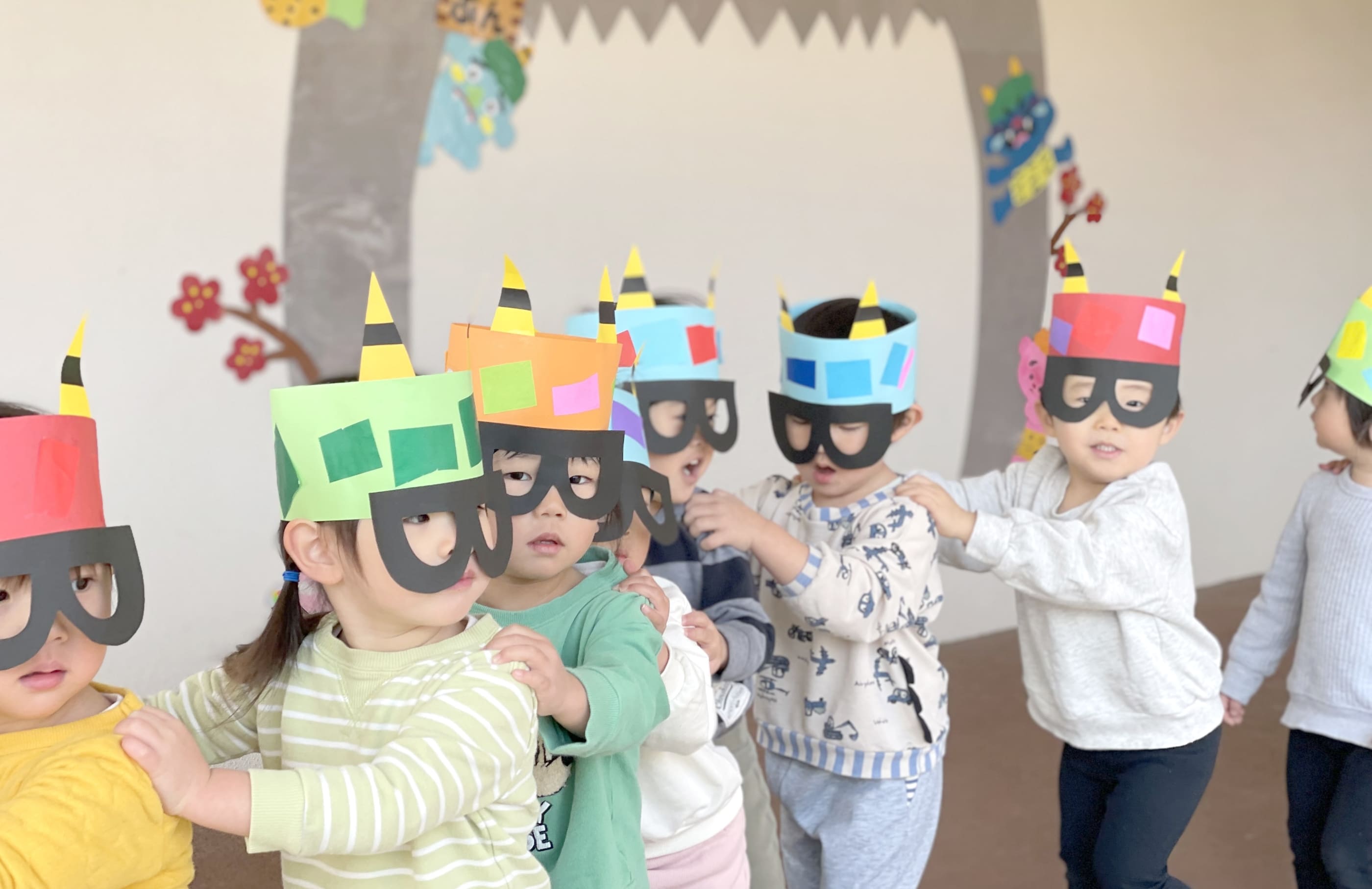 お面をつけて行列になってる子どもたち